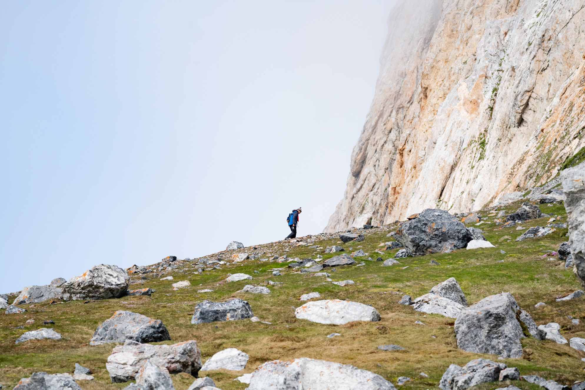 Hiker climbing a rocky ridge towards mountain, Gnalodden, Svalbard, Lina Stock @DivergentTravelers Hiker climbing a rocky ridge towards mountain, Gnalodden, Svalbard, Lina Stock @DivergentTravelers